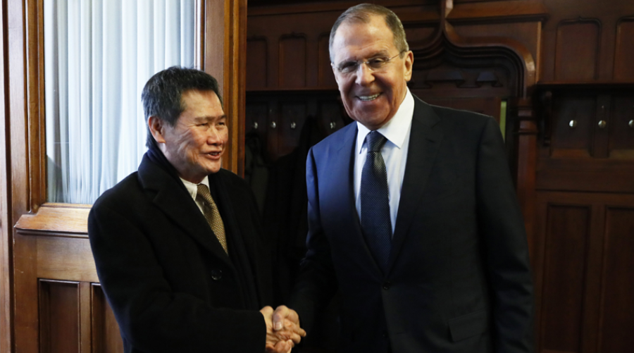 Two men in suits shake hands: one is Sergey Lavrov.